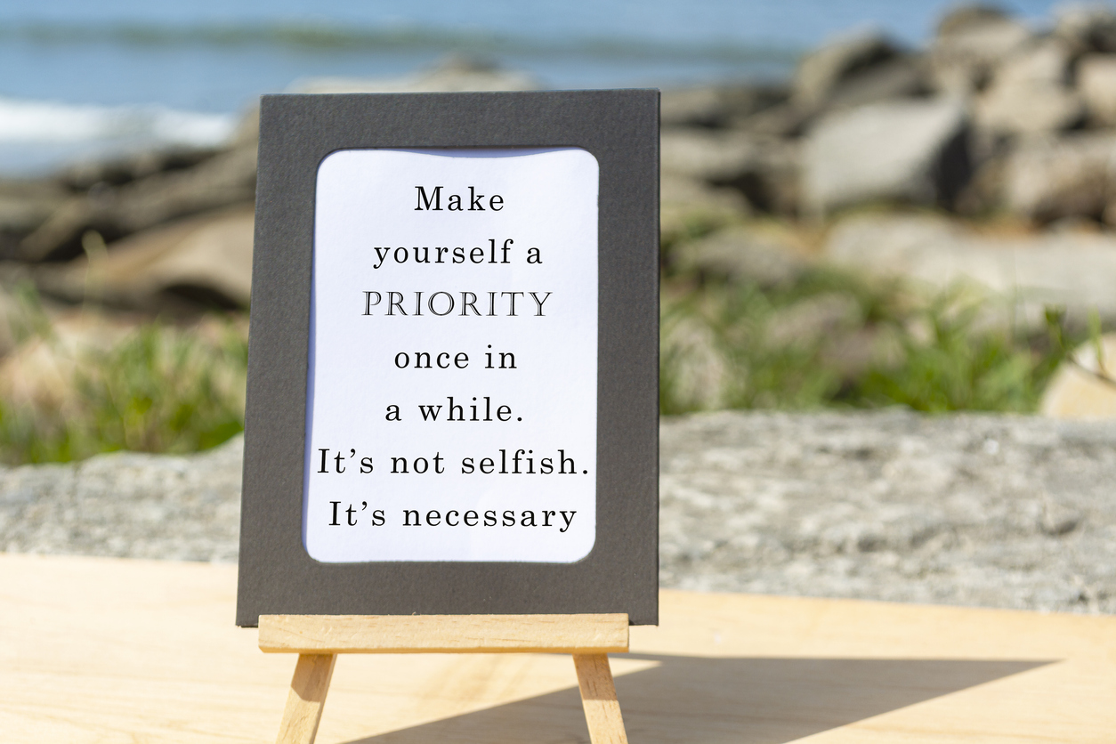 Motivational And Inspirational Quote On A Notepad With Blurred Beach Background